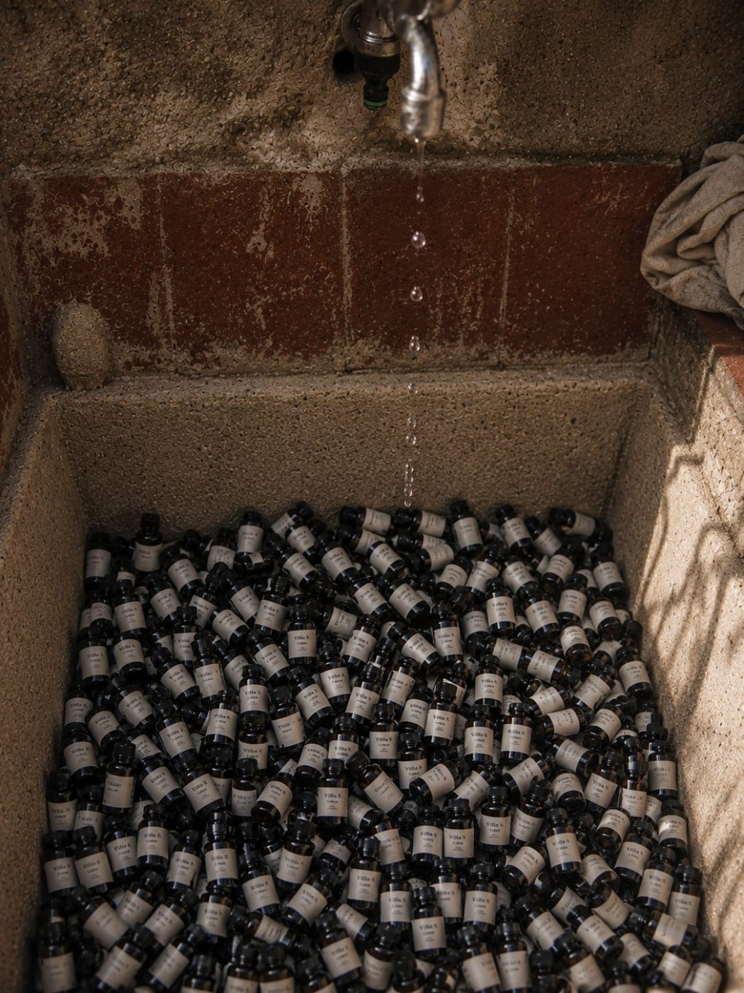 Hundreds of Villa S bottles resting in the old stone wash basin